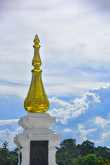 Fototapeta na wymiar Pagoda Wat Pa Ban Tat temple, Gold temple with beautiful cloudy in Udon Thani Thailand.