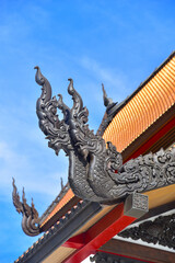 Fototapeta na wymiar Black naga Carved, on rooftop at Wat Pa Ban Tat temple in Udon Thani Thailand.