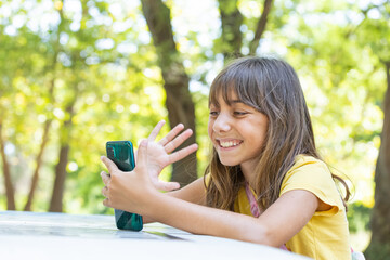 girl communicates on a mobile device in nature