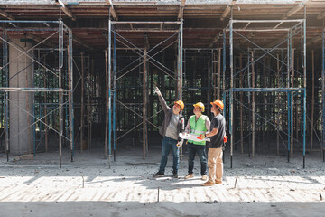 Construction concept of Engineer and Architect working at Construction Site with blue print