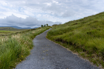 Fototapeta na wymiar landscape of hiking trail leading through the meadows and hills of the Ballycroy National Park in County Mayo