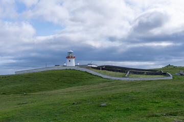 Fototapeta na wymiar view of the historic harbor lighthouse at St. John's Point in Donegal Bay in the north of Ireland