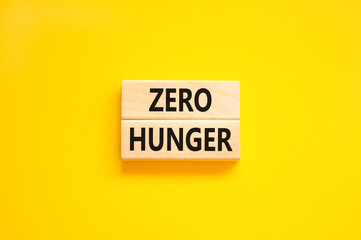 Zero hunger symbol. Concept words Zero hunger on wooden blocks on a beautiful yellow table yellow background. Business, support and Zero hunger concept. Copy space.