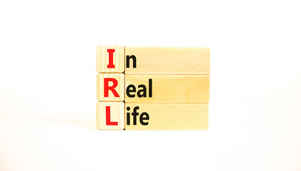 IRL in real life symbol. Concept words IRL in real life on wooden blocks on a beautiful white table...