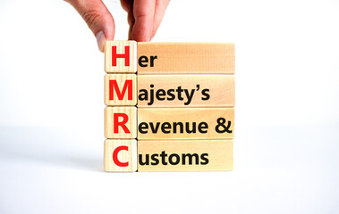 HMRC her majestys revenue and customs symbol. Concept words HMRC her majestys revenue and customs on blocks on beautiful white background. Business HMRC revenue and customs concept. Copy space.