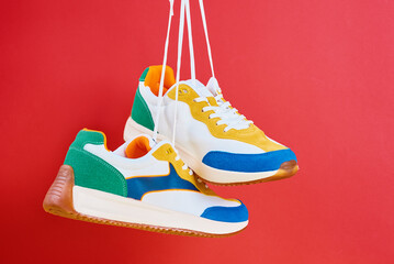 Flying trendy sneakers on creative colorful background, Stylish fashionable minimalism concept, Levitation shoes - obrazy, fototapety, plakaty