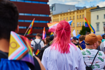Obraz na płótnie Canvas People crowd with LGBTQ rainbow flags on pride parade. Tolerance, diversity and gender identity concept