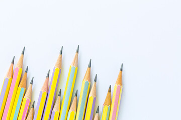 wooden pencil on a white background,Three red and yellow graphite pencils isolated on white
