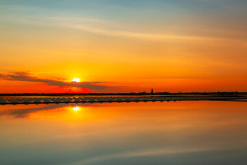 Fototapeta premium Salt farm in Thailand,Salt industry,sunset on a pink salt lake,Sunset salt farming Naklua in the coastal, Phetchaburi provinces of Thailand, Landscape, a former mine for the extraction of pink salt