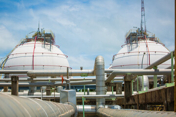 Naklejka premium White spherical propane tanks containing fuel gas pipeline
