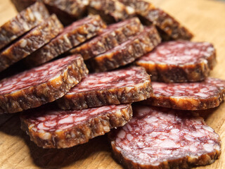 Meat appetizer. Dried sausage, macrophoto. Lots of sausage slices.