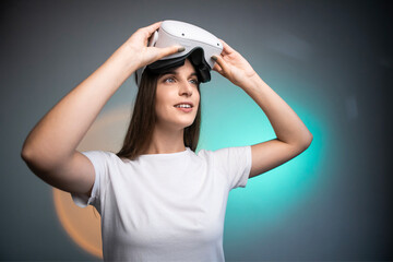 Fototapeta na wymiar Woman using a virtual reality headset isolated on colorful background