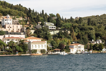 Fototapeta na wymiar View of historical, traditional mansions by Bosphorus in Anadolu Hisari area of Asian side of Istanbul. It is a sunny summer day. Beautiful travel scene.