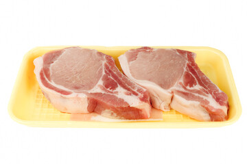 Pork chops in a supermarket package isolated on white background. Side view.