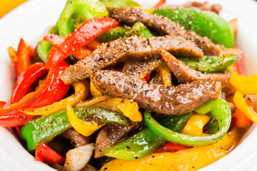 A plate of fried beef cubes with green pepper