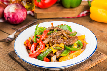 A plate of fried beef cubes with green pepper