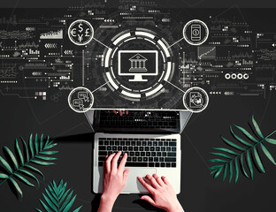 Fintech theme with person using a laptop computer