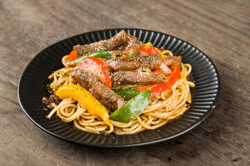 A plate of delicious pasta with beef and green pepper