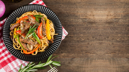 A plate of delicious pasta with beef and green pepper