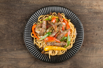 A plate of delicious pasta with beef and green pepper