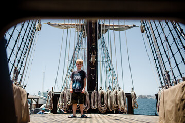 Eight Year Old Boy Posing on Sailboat at Maritime Museum in San Diego