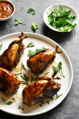 Roasted quails on white plate