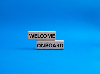 Obraz premium Welcome onboard symbol. Concept words Welcome onboard on wooden blocks. Beautiful blue background. Business and Welcome onboard concept. Copy space.
