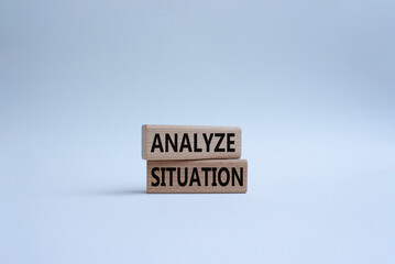 Analyze situation symbol. Wooden blocks with words Analyze situation. Beautiful white background....