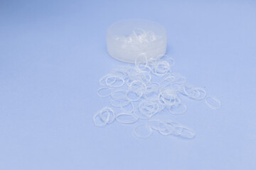 Disposable transparent hair bands on purple background