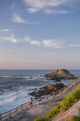 Background of a sea breaking on a cliff at sunset