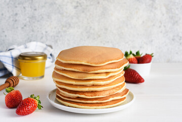 Stack of honey pancakes, homemade strawberry pancakes for breakfast