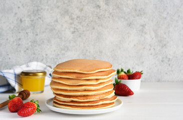 Stack of honey pancakes, homemade strawberry pancakes for breakfast