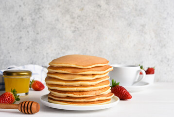 Stack of honey pancakes, homemade strawberry pancakes for breakfast