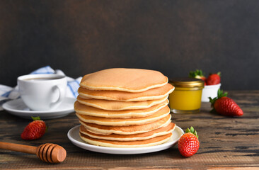 Stack of pancakes. Homemade pancakes with berries for breakfast on a dark background