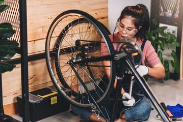 Beautiful asian woman repairman girl ,bike maintenance with happy and replace a bike chain, self...