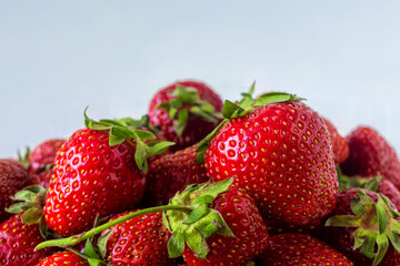 Fresh ripe bright red strawberries with green leaves