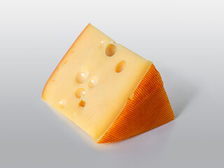 Piece of cheese with large holes on a light gray background