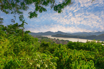 Fototapeta na wymiar Luang Prabang Laos, beautiful river surrounded by lush green mountains and lovely historical houses