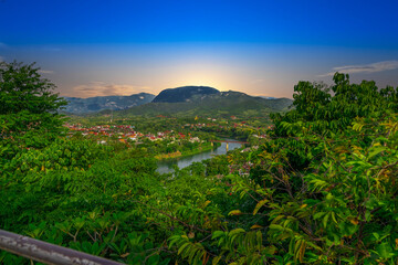Fototapeta na wymiar Luang Prabang Laos, beautiful river surrounded by lush green mountains and lovely historical houses