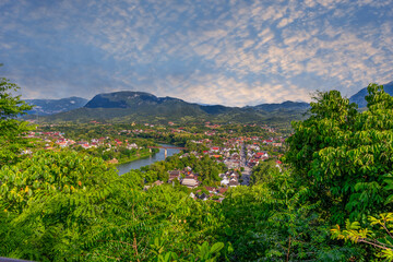 Obraz premium Luang Prabang Laos, beautiful river surrounded by lush green mountains and lovely historical houses