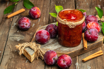 plum jam nd fresh plums on a wooden background. banner, menu, recipe place for text