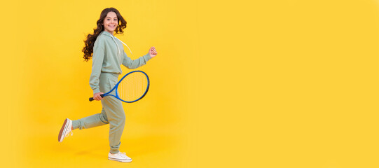 happy energetic kid jump in sportswear with tennis racket running to success, active childhood. Horizontal poster of isolated child face, banner header, copy space.