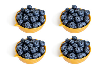 Four bowls of fresh organic blueberries isolated on white background. Healthy breakfast option.
