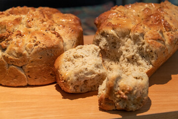 Freshley baked mosbolletjies (rusks) broken to see the inside with a glazed crust on top