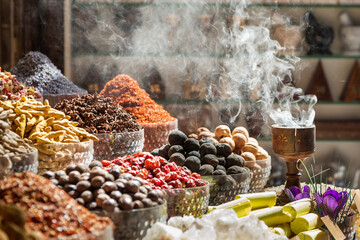 Various spices and bukhoor agar wood burner at Dubai spice market, United Arab Emirates