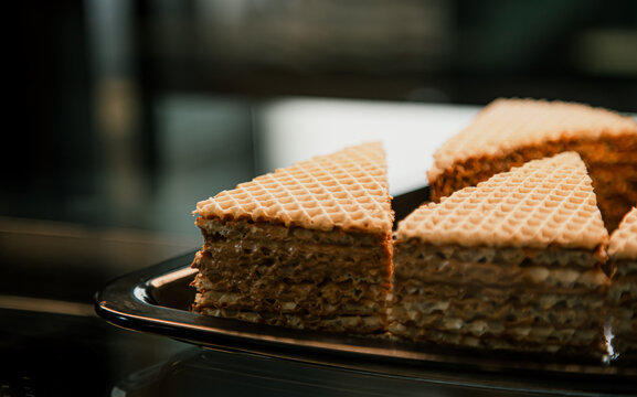 Pieces of waffle cake on display in a cafe.