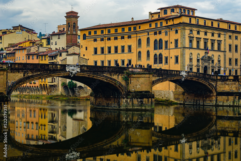 Wall mural bridge ponte santa trinita over arno river and church of saint james on the arno in florence.