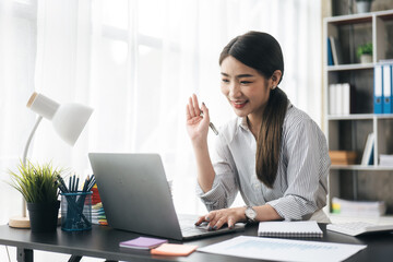 Young business women working and greeting on video conference with happy and smile face on office spec.