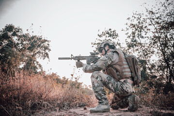 The soldiers pointed a gun at the enemy,selective focus