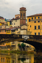Bridge Ponte Santa Trinita over Arno river and Church of Saint James on the Arno in Florence.